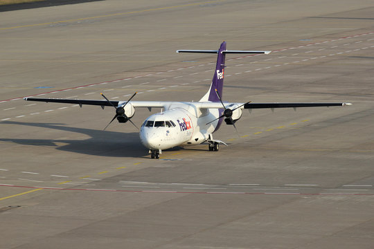 COLOGNE, GERMANY - APRIL 9, 2015: FedEx Feeder ATR 42F with registration EI-FXB on the ramp of Cologne Bonn Airport.