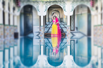 Pink and Yellow Indian Costume Beautiful Girl, face partially covered with saree. Portrait of Traditional woman in sari dress.