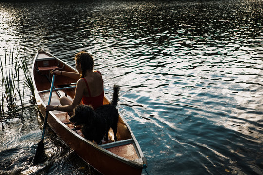 back of teen girl and her dog in Canoe