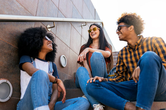 Group of happy friends having fun in the street