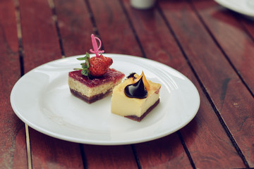 Two little cakes with cream and decoration on the table, close-up - Image