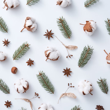 Composition of acorns, cotton, dry leaves and green branches of a Christmas tree on a gray background. Natural pattern as a layout for a postcard. Flat lay