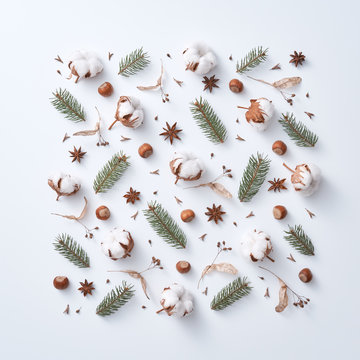 Natural pattern of green branches of a Christmas tree, dry leaves, cotton and anise on a gray background. Christmas card concept. Flat lay