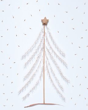 Christmas composition of dry twigs, leaves and paper stars in the shape of a christmas tree on a gray background. Flat lay