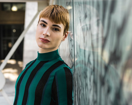 Young beautiful androgyne in striped shirt