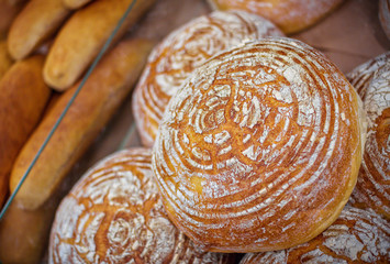 Freshly baked homemade bread with golden crispy crust. Food background.