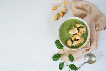 Vegetarian broccoli and spinach soup with croutons. Green healthy food concept. Horizontal orientation with copy space.