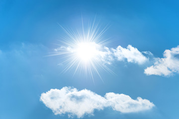 Fototapeta na wymiar Sun with sun rays on the blue sky with clouds