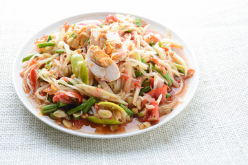 Papaya Salad with Satled Eggs, Pound chilies and garlic then place sliced tomato, eggplant and salted egg. Add fish sauce, lemon, sugar, chopped papaya then mixed all the ingredients together.