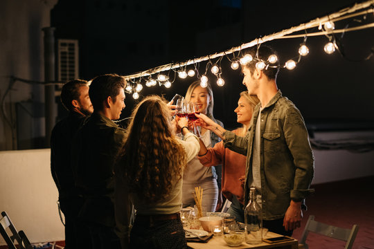 Cheerful friends burning sparklers