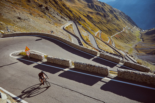 Cyclist climbing passo dello stelvio.