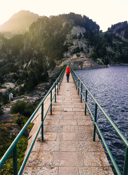 Female hiker walking on a dam
