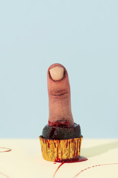 small cake with a finger