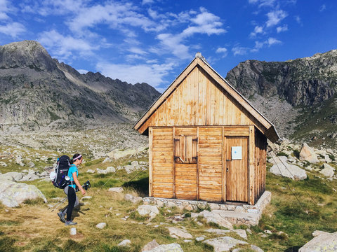Female hiker reaching an alpine shelter during an hike