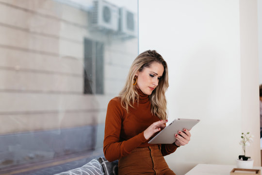 woman using tablet in cafe - Powered by Adobe