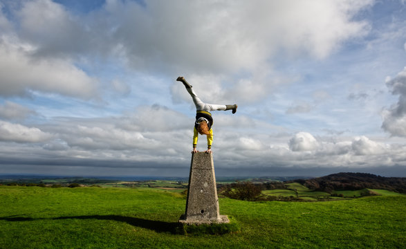 Boy doing a raised handstand.