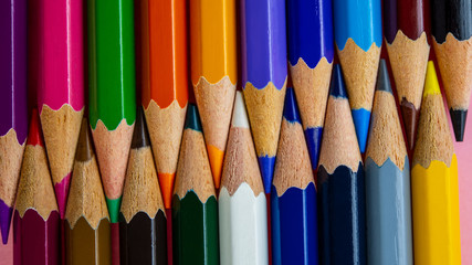 multi-colored pencils in a set lie against each other.