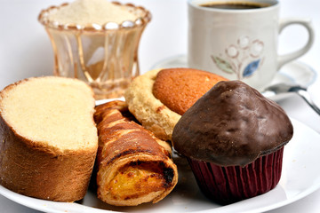Traditional sweet bread, made with handcrafted veracruzanas, the name of the bread is chocolate pancake, pancha eye, pineapple puff pastry, butter slice, in the background a warm coffee with sugar