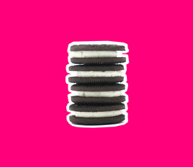 Chocolate cookie sandwich stack with white outline and pink background.  Dessert food pop art style image, cookies and cream flavor concept.