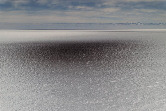 View of vast ocean, horizon and sky at dusk