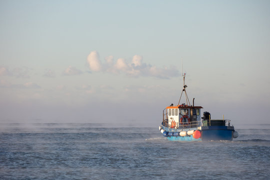 Fishing boat at dawn.