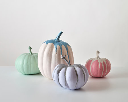 Creative Halloween composition from colorful paited pumpkin isolated on a white background. Greeting card.