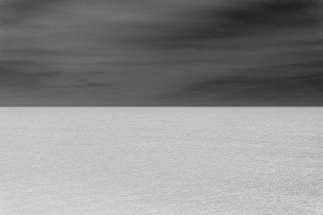 Abstract of vast ocean, horizon and sky at dusk