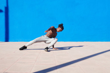 Black muscular man dancing in yard