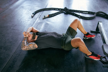 Strong man resting in gym.