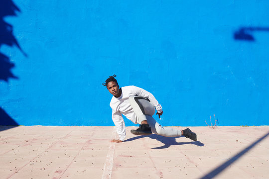 Young black man dancing on street