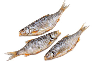 Dried fish-Rutilus rutilus lacustris - on the table. Salty dry fish on white background. Isolated on white background.
