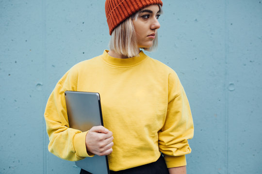 Stylish woman walking against the blue background