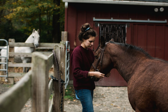 teen getting her horse ready for riding