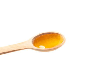 Wooden spoon with honey isolated on white background, closeup