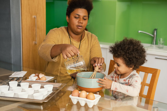 Mother And Daughter Making Chocolate Cupcakes