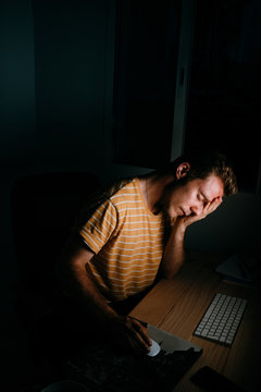 handsome man working at night in front of his computer