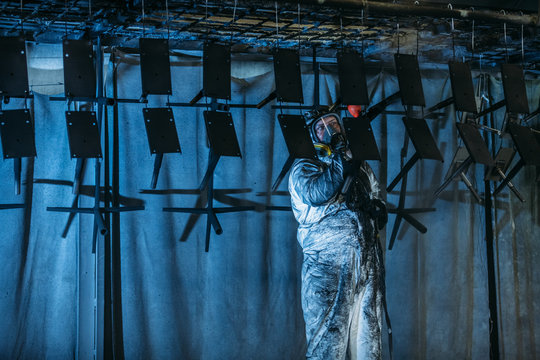 Worker painter at industrial factory