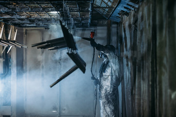 Worker painter at industrial factory