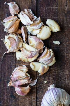 smashed garlic on a wooden board
