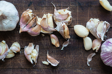 smashed garlic on a wooden board