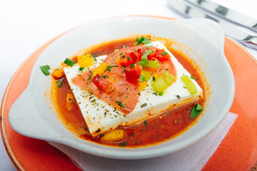 Greek cheese in a sauce with tomatoes and herbs