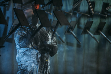 Worker painter at industrial factory