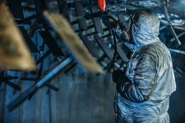 Worker painter at industrial factory