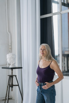 Portrait od a senior woman with grey long hair in studio