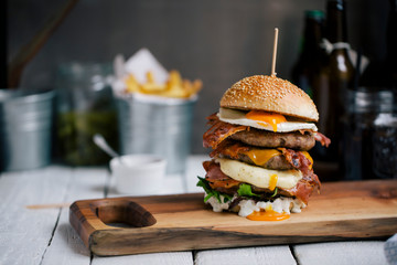 Mouth-watering burger on wooden board