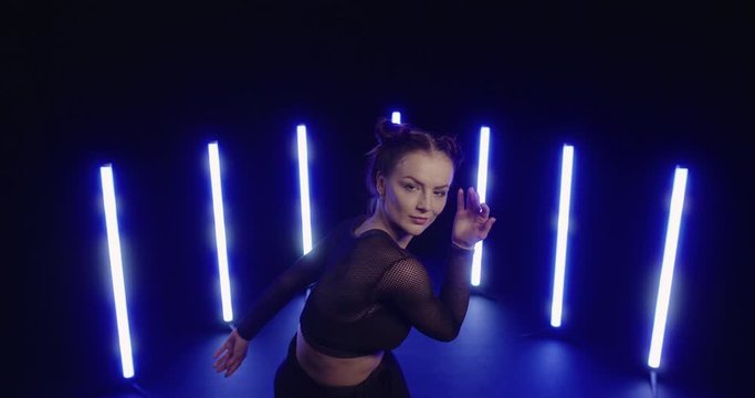Studio, slow motion, female modern dancer showing off moves, London