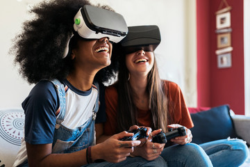 Female friends playing video games at home