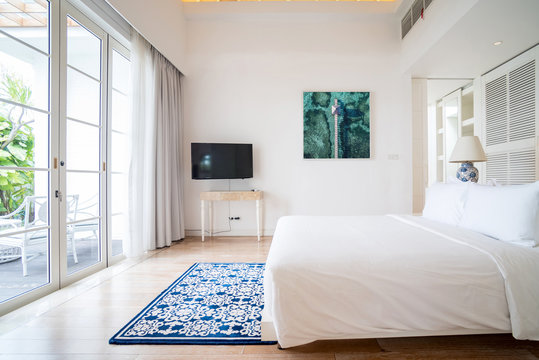 Interior of spacious white bedroom decorated