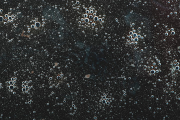  an abstraction depicting many small bubbles in the black wilderness. chaotic abstraction pattern....