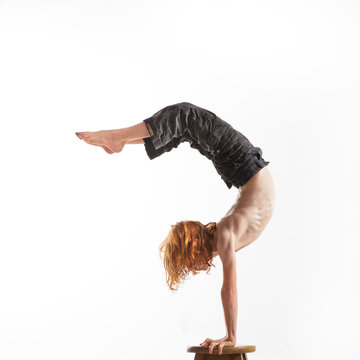 Young red-headed boy doing a handstand